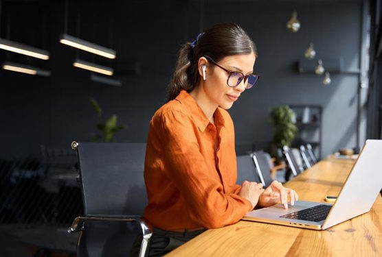 Business professional is working on a laptop.